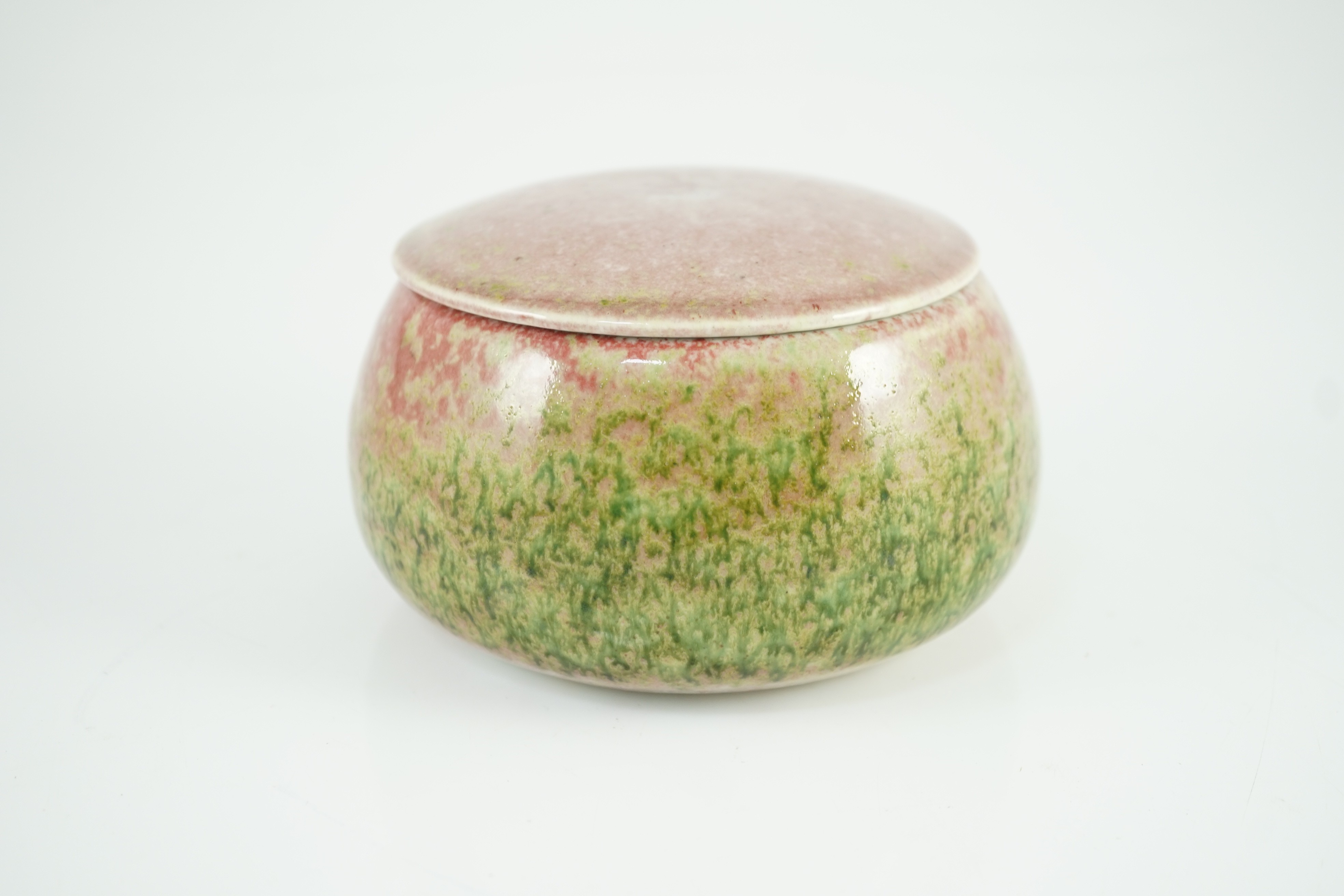 A Chinese peachbloom glazed weiqi stone box and cover, 20th century, 13.5cm diameter